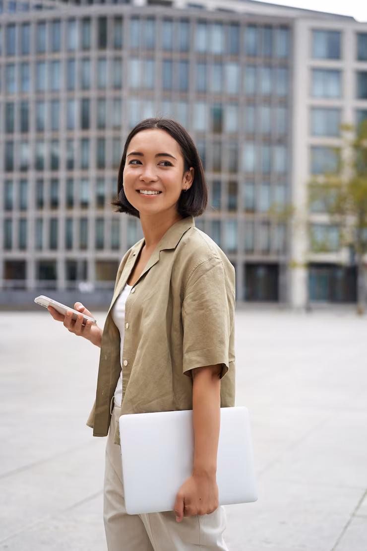 vertical-shot-asian-girl-walks-with-laptop-city-street-smiles_1258-119467 vertical-shot-asian-girl-walks-with-laptop-city-street-smiles_1258-119467