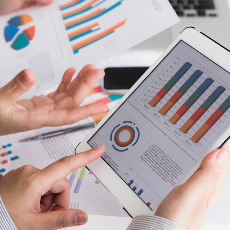 close-up-business-team-using-digital-tablet-with-financial-d_1232-2081