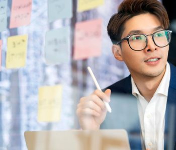 smart-attractive-positive-asian-business-male-wearing-glasses-work-remote-new-normal-lifestyle-hand-use-laptop-tele-conference-onlive-videocall-meeting-remote-business-ideas-concept_609648-984